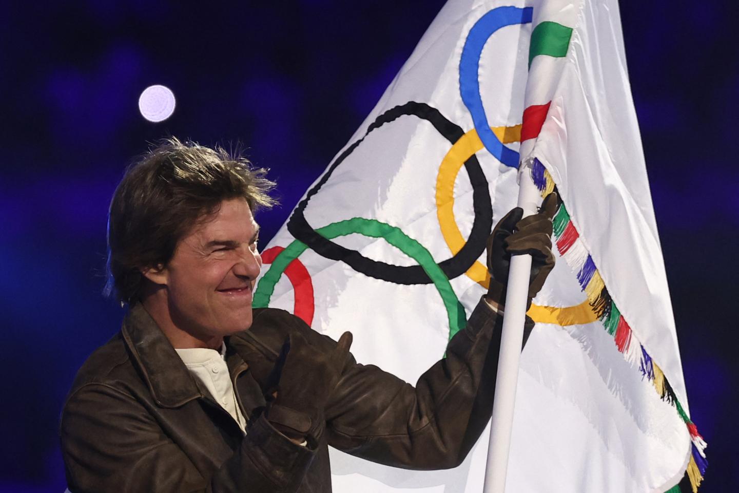 TOPSHOT - US' actor Tom Cruise waves the Olympic flag during the closing ceremony of the Paris 2024 Olympic Games at the Stade de France, in Saint-Denis, in the outskirts of Paris, on August 11, 2024. (Photo by Franck FIFE / AFP) (Photo by FRANCK FIFE/AFP via Getty Images)
