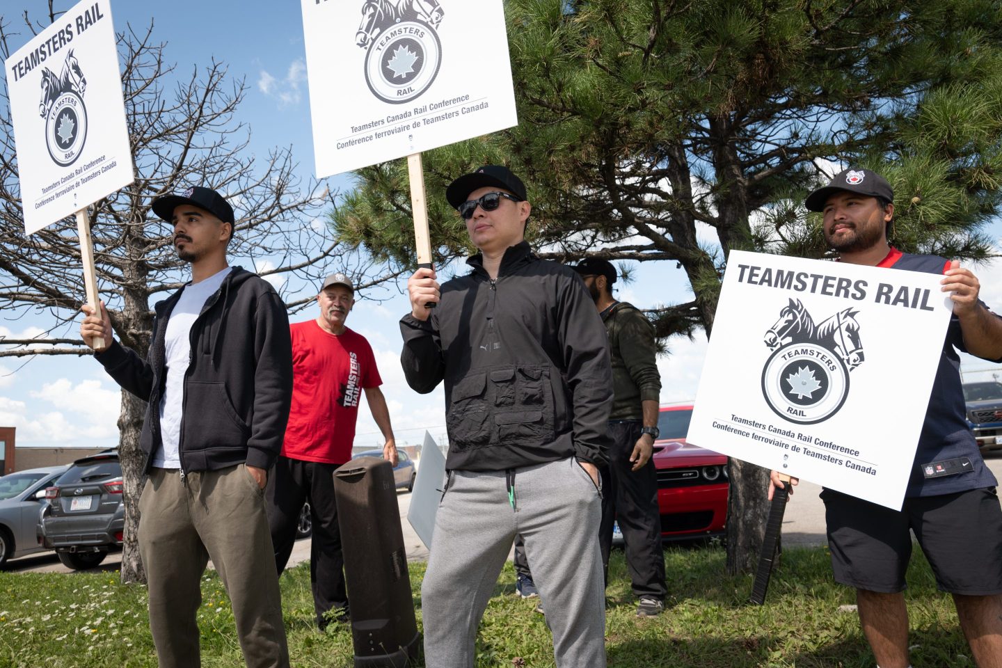 workers hold picket signs