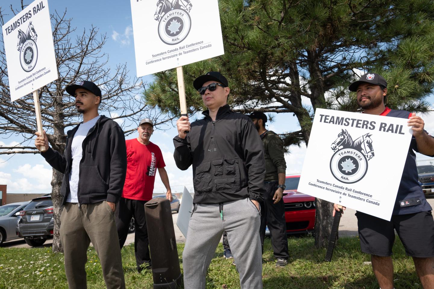 workers hold picket signs