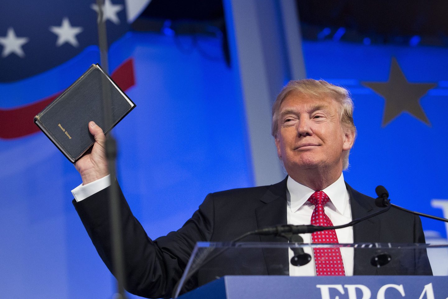 Former President Donald Trump holding a Bible during a speech