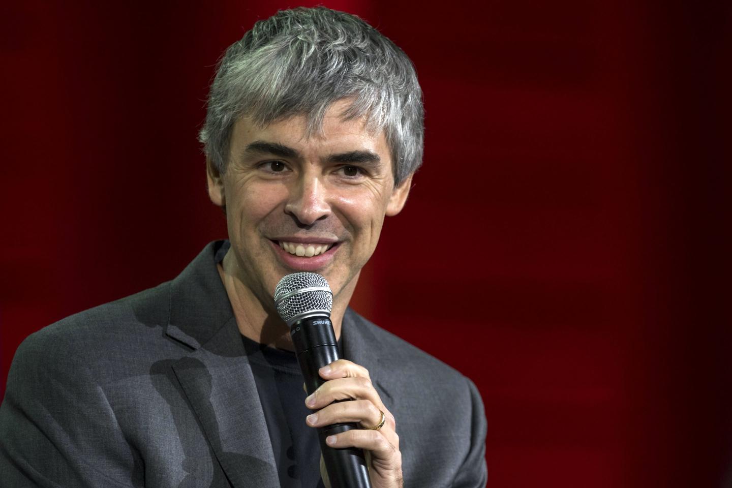 Photo of Larry Page speaking into a microphone