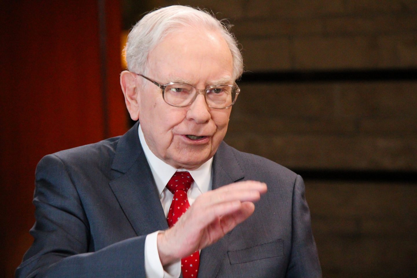 Warren Buffett gestures with hand
