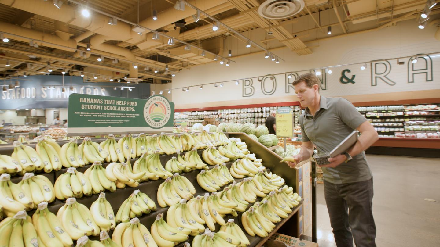 Jason Buechel shopping for organic bananas at Whole Foods.