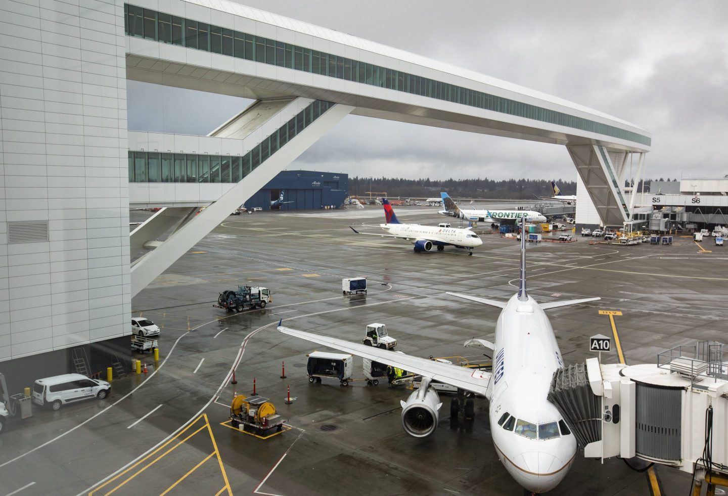 Planes taxi under the aerial passenger walkway at Seattle-Tacoma International Airport, March 3, 2022, in Seattle.