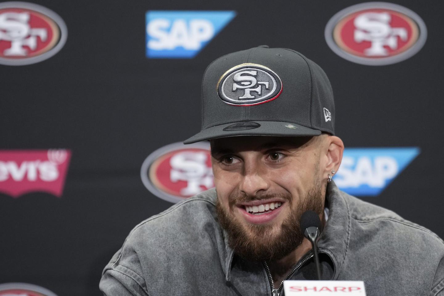 Ricky Pearsall smiles at a press conference