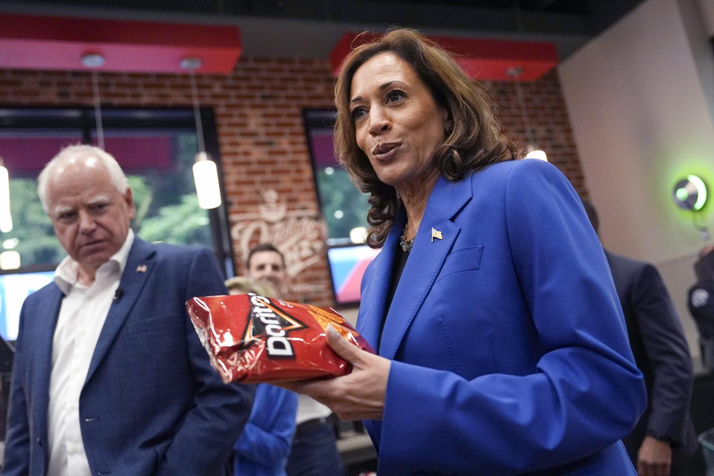 Kamala Harris holds a bag of Doritos