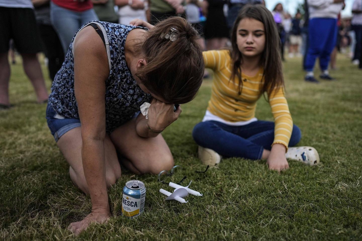 A girl consoles her friend after a shooting at a Georgia high school