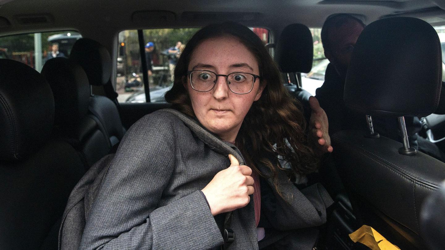 Caroline Ellison is seen getting out of a car at a court appearance.