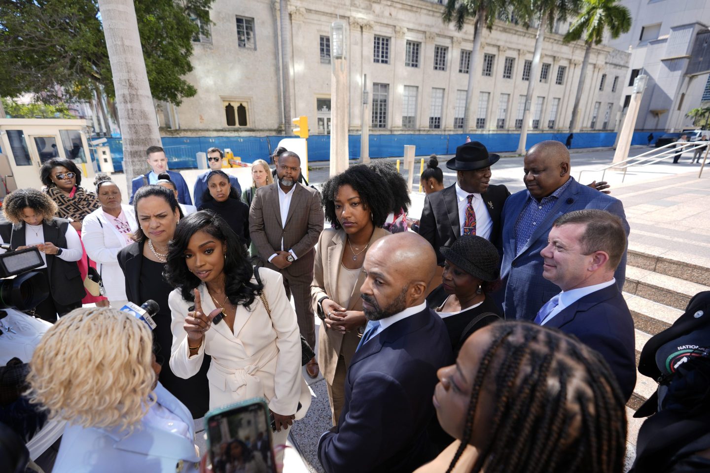 o-founders and CEOs of The Fearless Fund Arian Simone, center left, and Ayana Parsons, center right, speak to journalists outside the James Lawrence King Federal Building in Miami.
