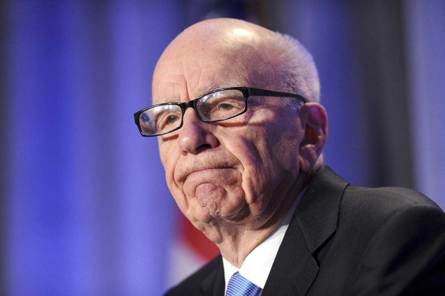 News Corp. CEO Rupert Murdoch is seen at an event wearing a suit and glasses.