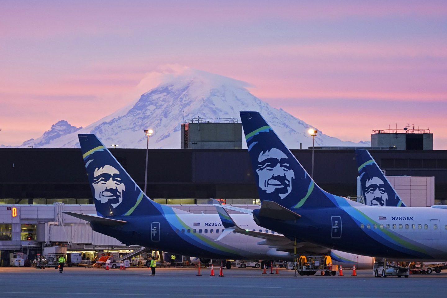 Alaska Airlines planes are shown parked at gates with Mount Rainier in the background on March 1, 2021, at Seattle-Tacoma International Airport in Seattle. 