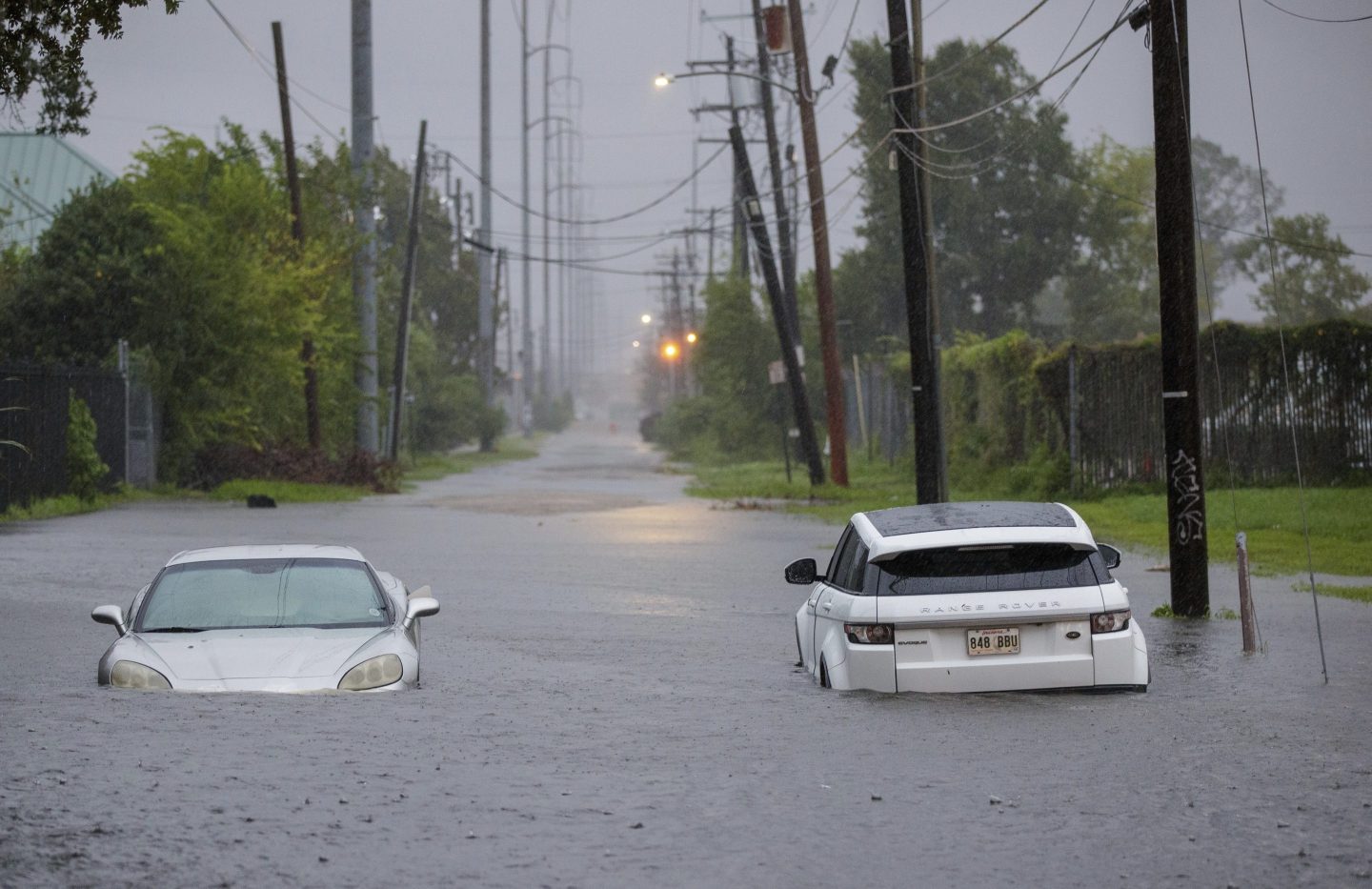 Two vehicle on Olive Street are flooded during Hurricane Francine in New Orleans.