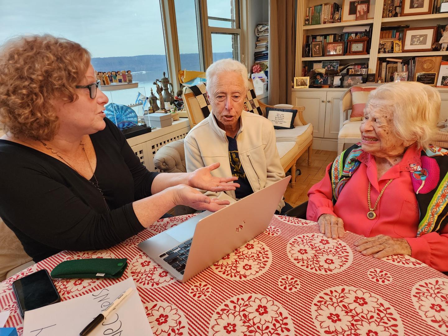 Gilbert sits in Westheimer's home, working on the book, 