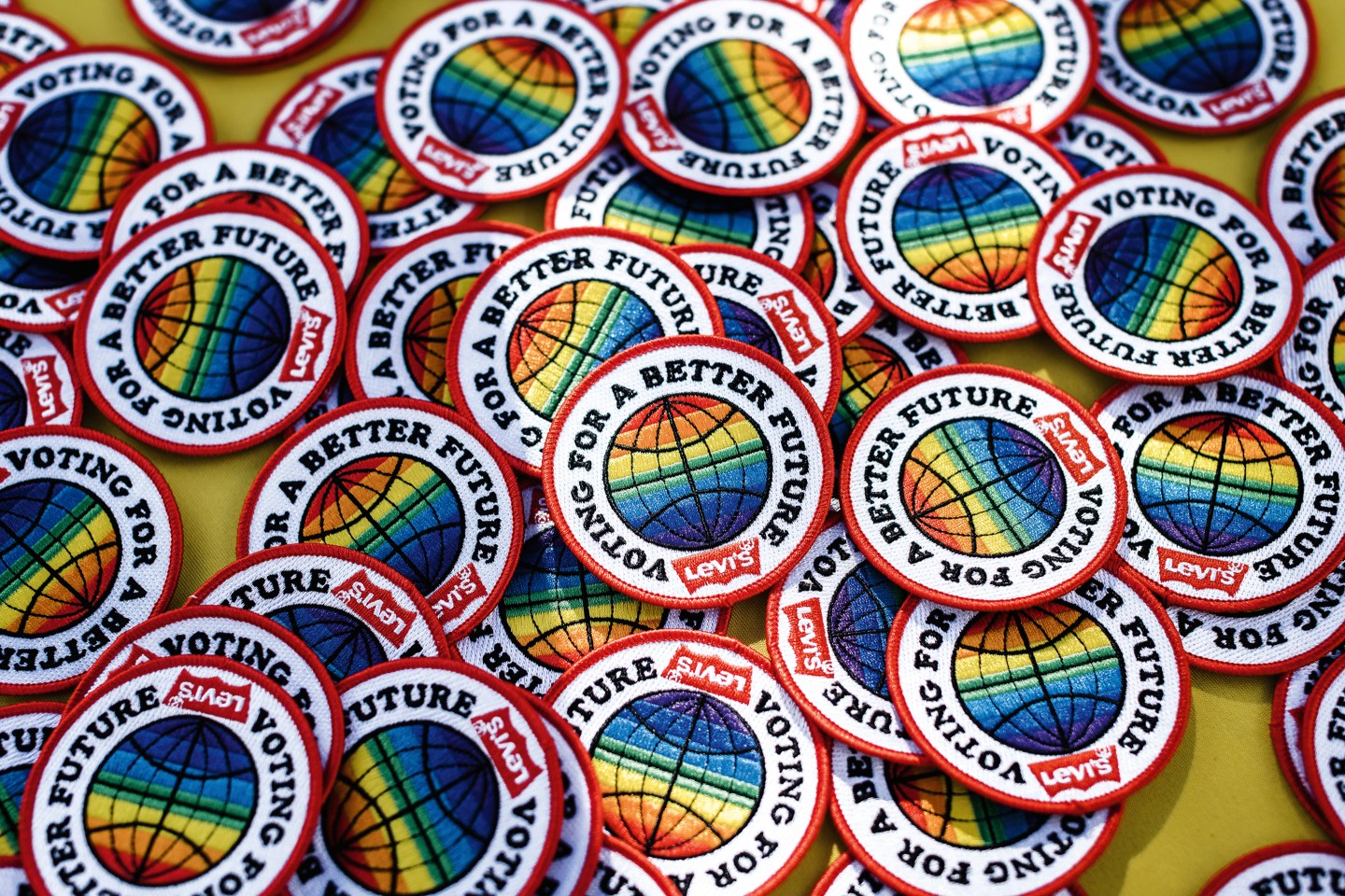 Buttons on a table that say 'Voting for a better Future, Levis