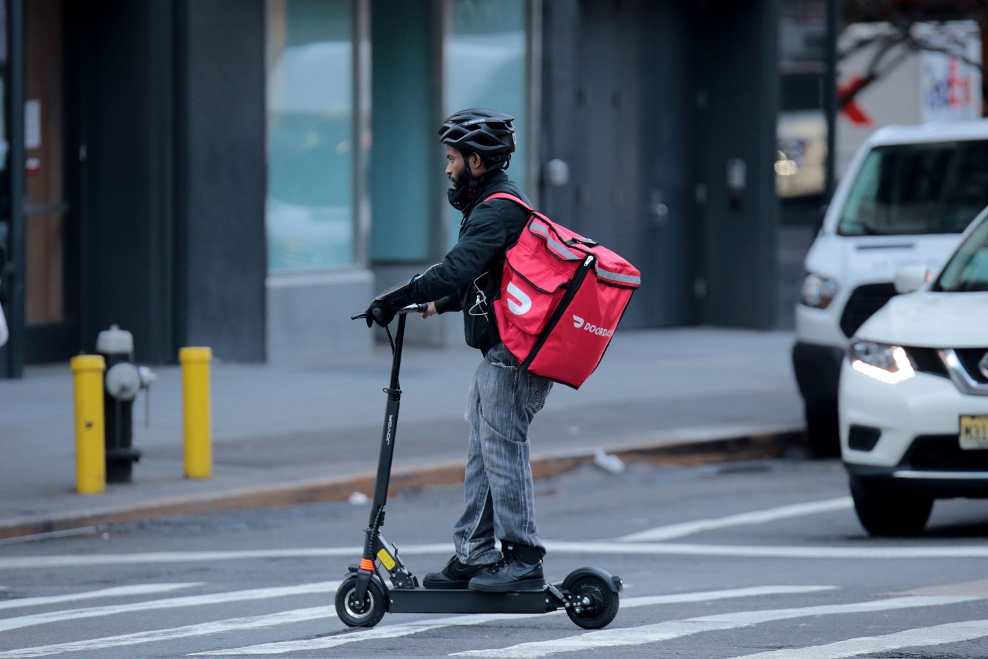 DoorDash delivery worker on a scooter in Manhattan.
