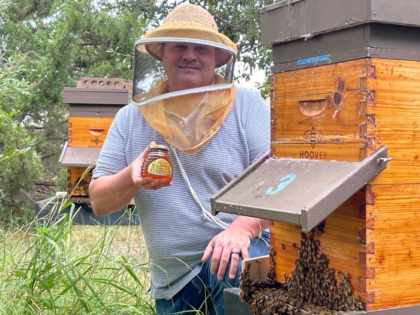 AT&T engineer Eddy Barker busy with beekeeping.