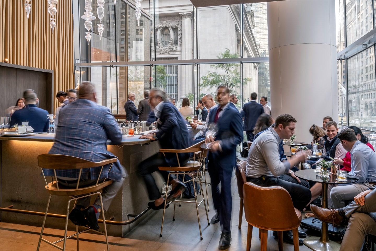 Professionals sit at a bar and tables during power hour at Le Pavillon.