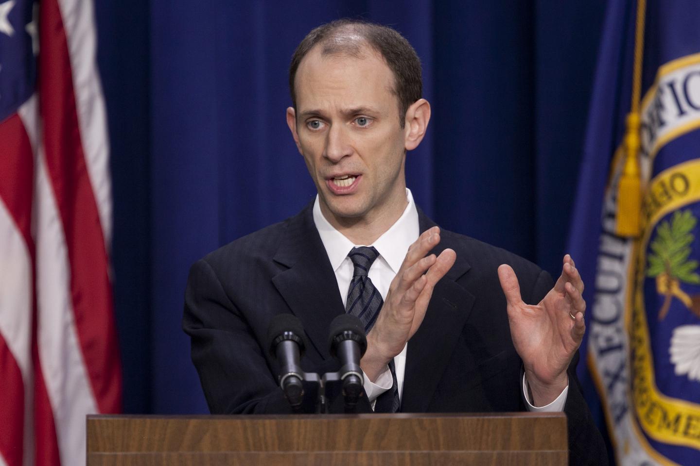 Austan Goolsbee during the Obama administration. He is speaking at a podium in a suit.