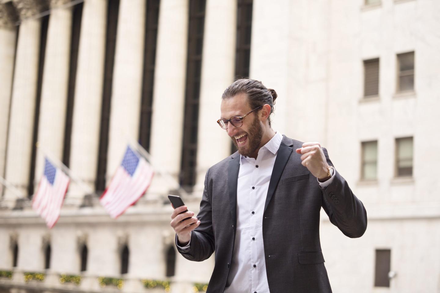 A man looks pumped outside the New York Stock Exchange