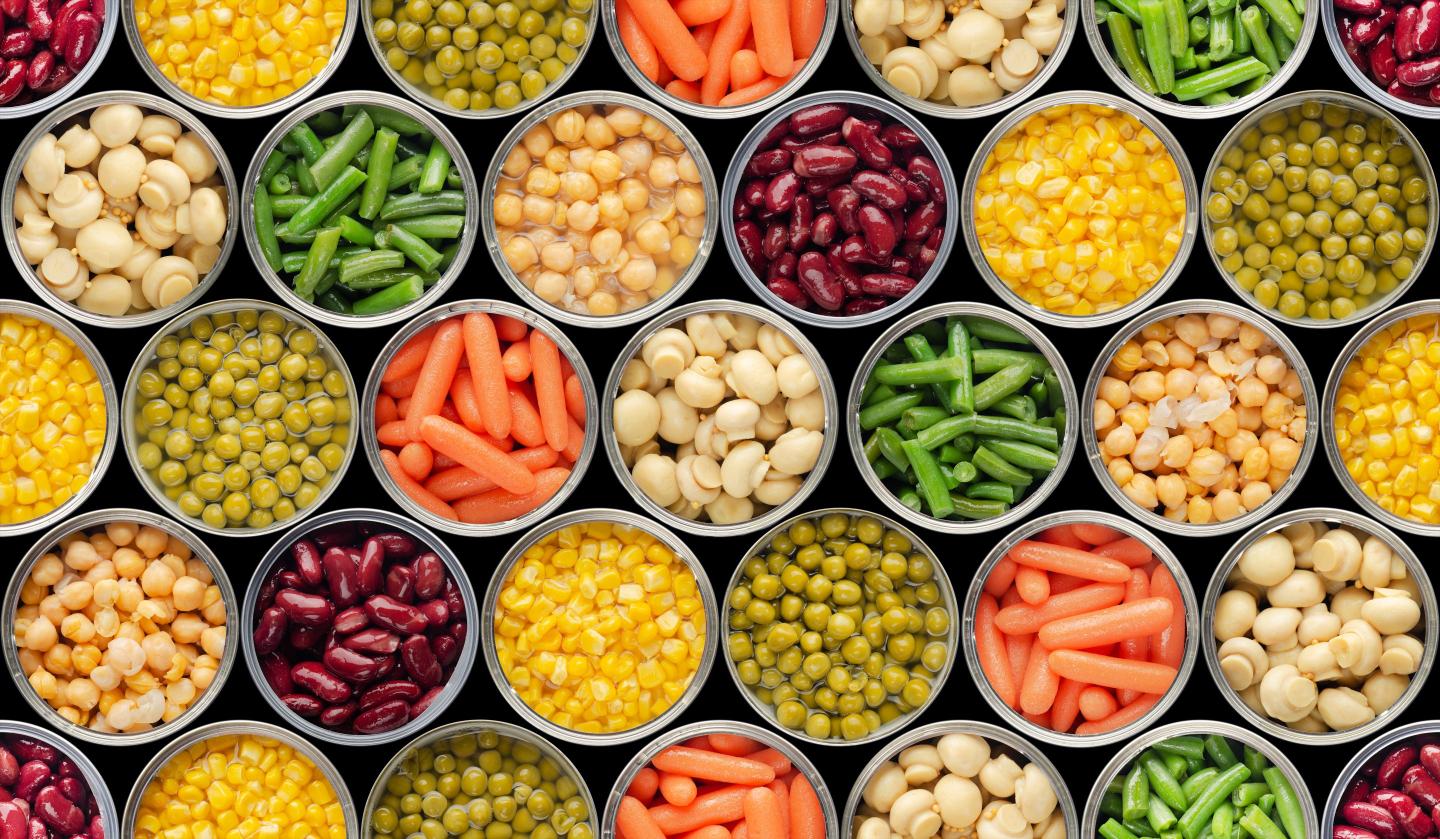 Opened canned food with various veggies and legumes featured.