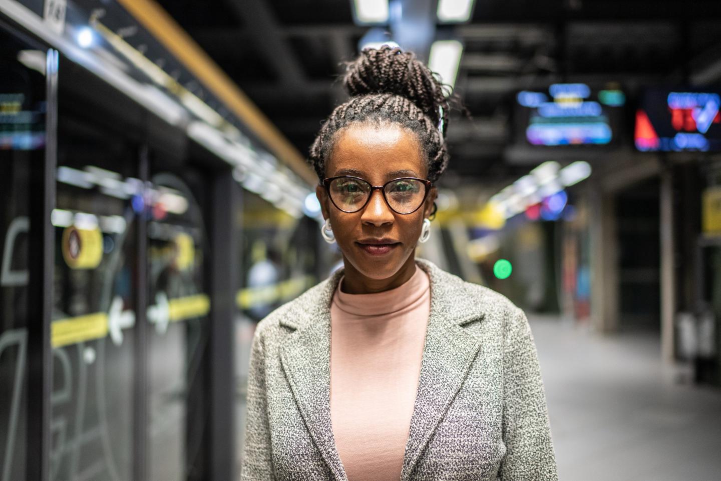 A woman standing in a subway station
