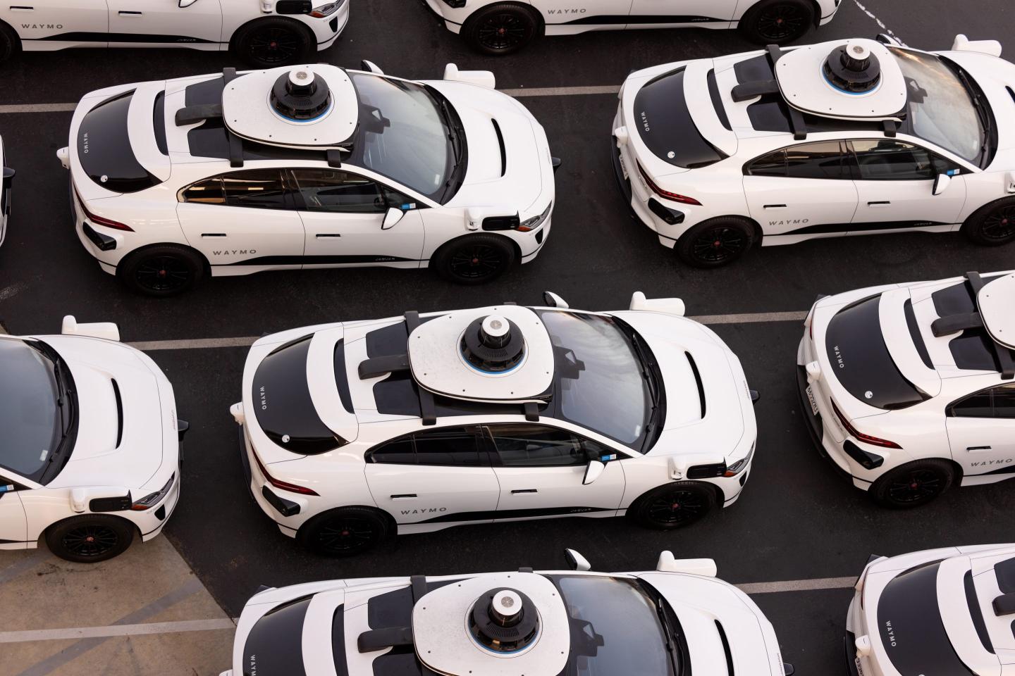 Aerial view of Alphabet's Waymo self-driving car fleet storage facility showing the black and white vehicles.