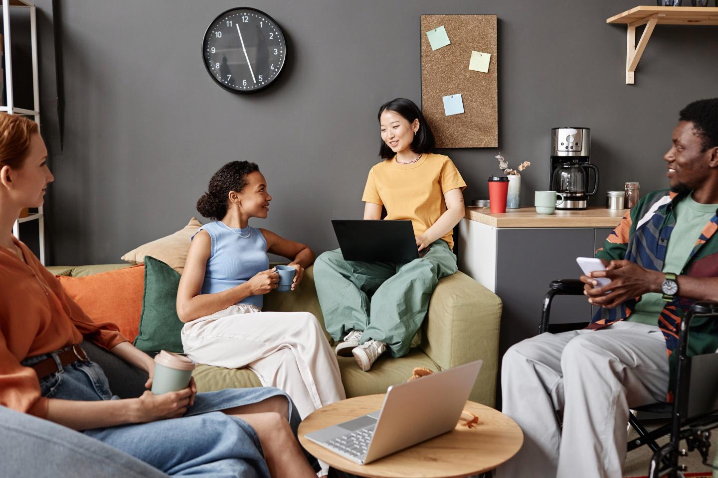 Gen Z workers talk together at the office.