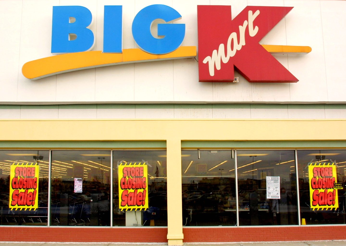 Store signs announcing a store closing sale are on display on the windows of a Kmart store that is scheduled to close back in 2003.