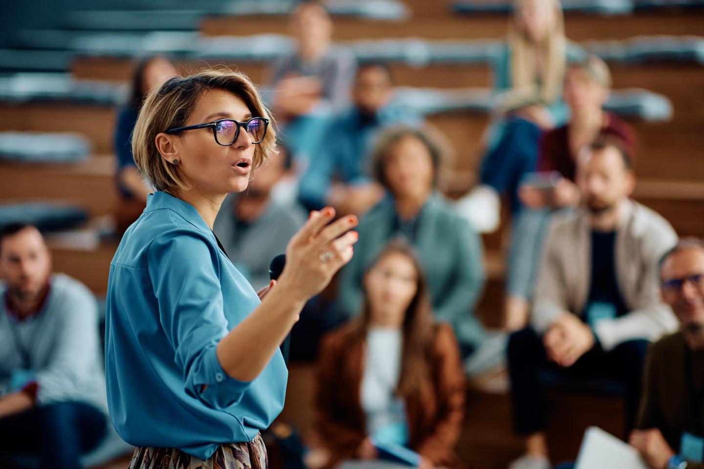 Executive gives presentation in front of workers.
