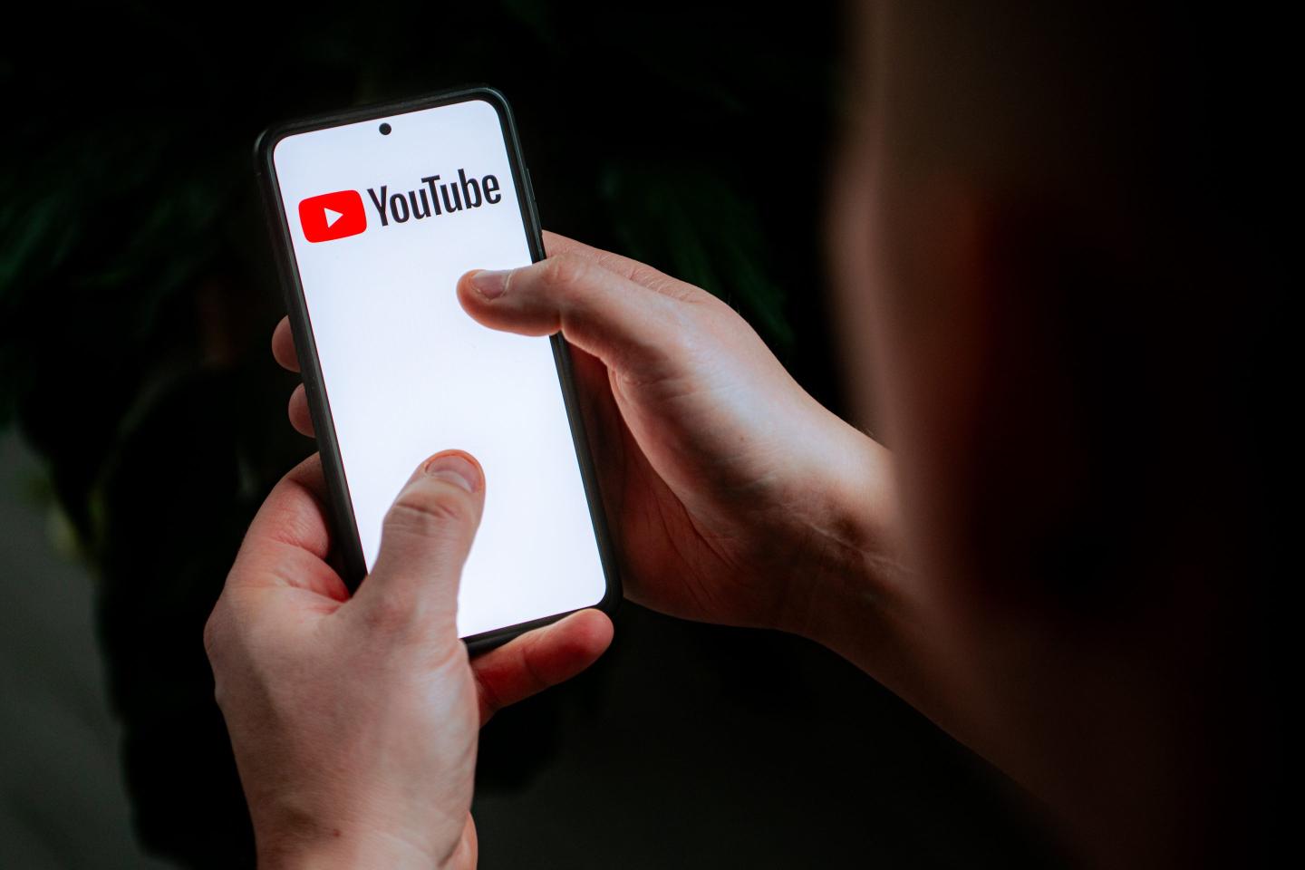 In this photo illustration a YouTube logo seen displayed on a smartphone.