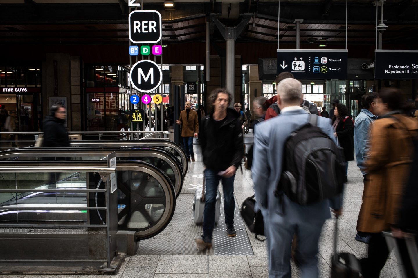 People seen walking in a busy train station