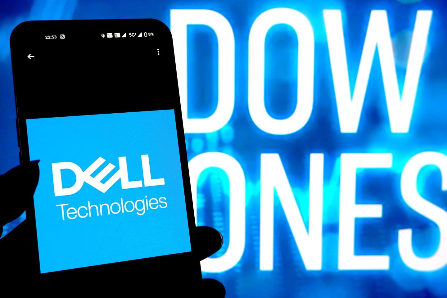 A Dell Technologies logo seen displayed on a smartphone with Dow Jones logo in the background.