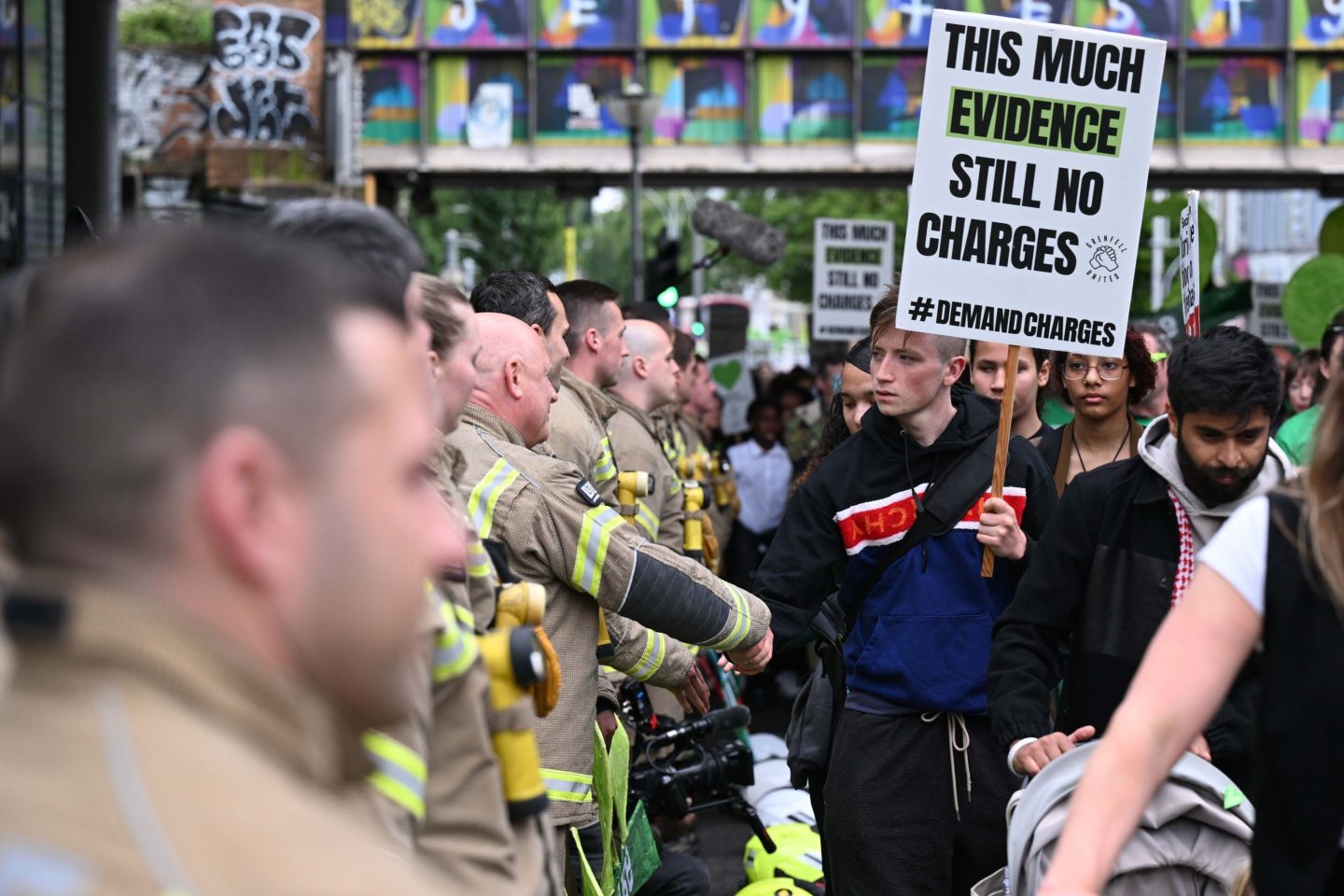 People including firefighters attend the service of remembrance to mark the seventh anniversary of the Grenfell Fire.