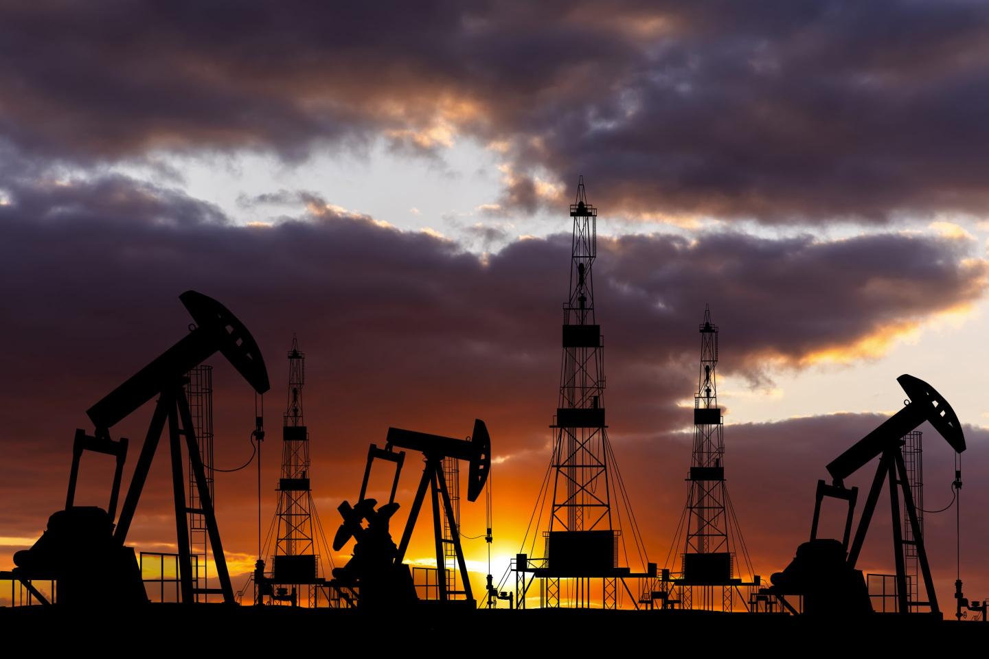 oil rigs at sunset