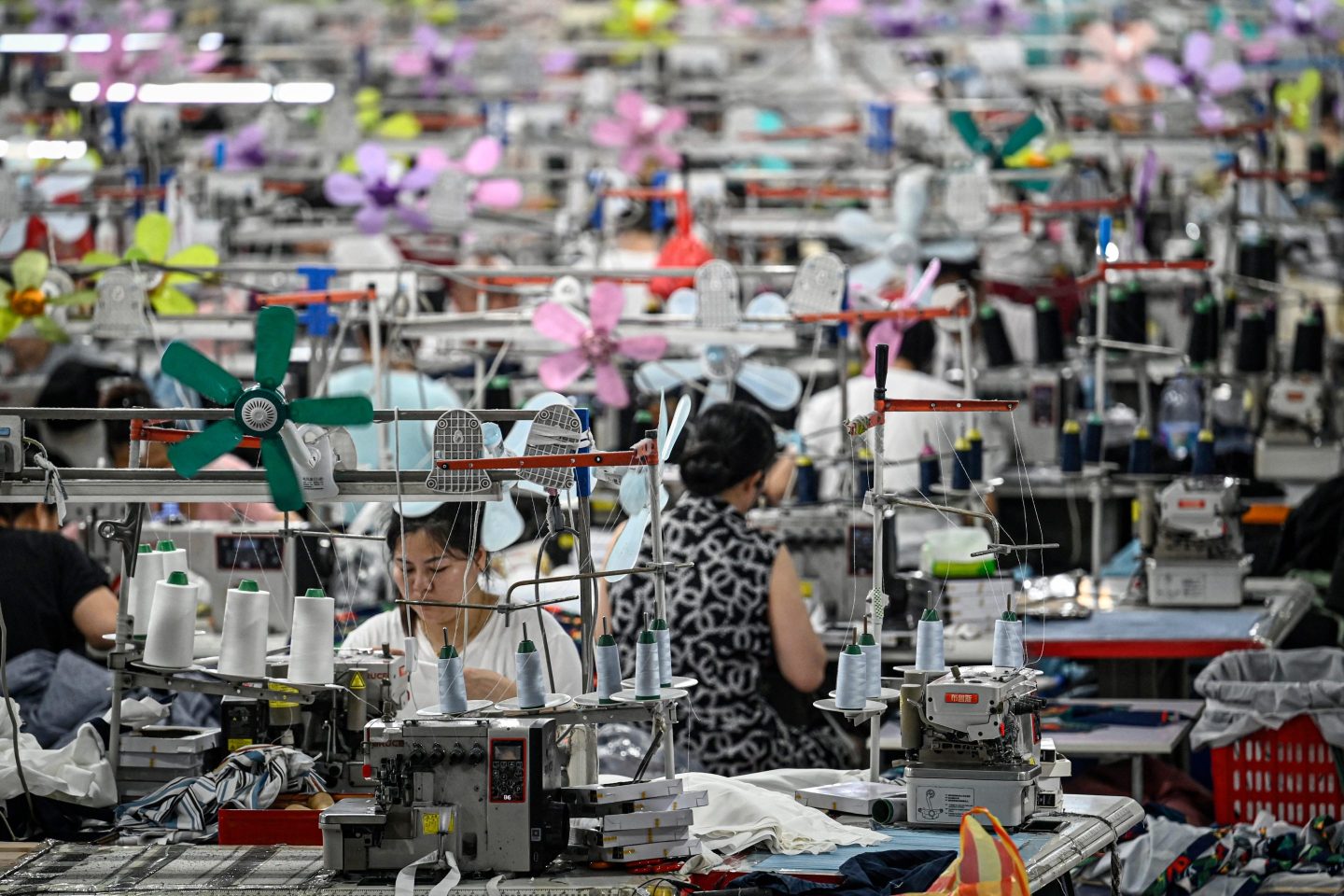 Workers produce garments at a textile factory that supplies clothes to fast fashion e-commerce company Shein in Guangzhou in southern China's Guangdong province, on June 11, 2024.