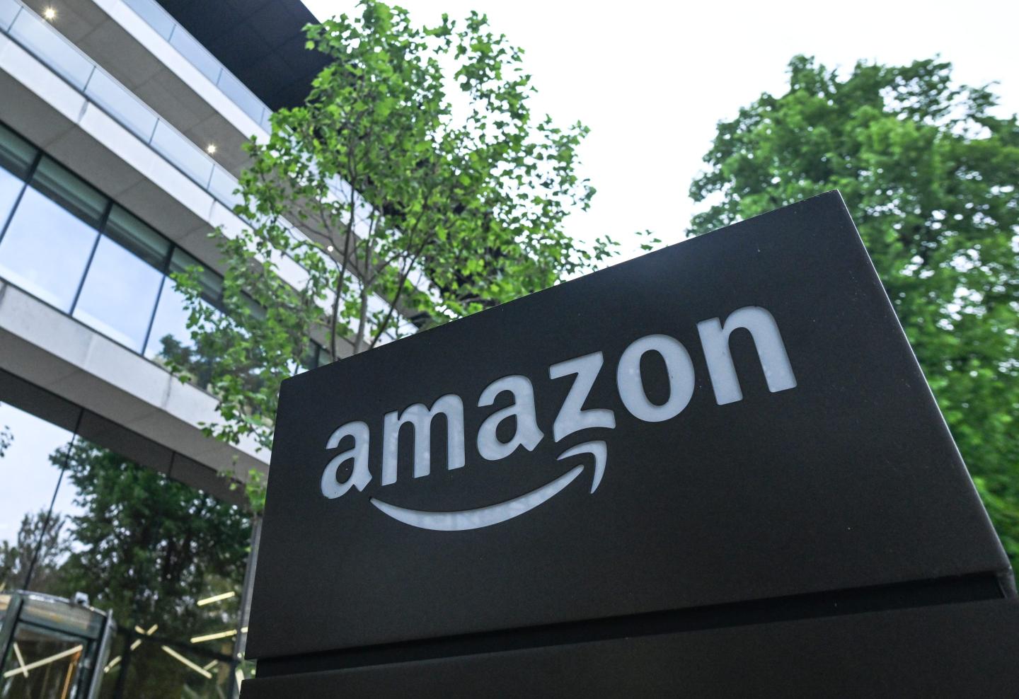 The Amazon logo is seen on a plaque outside a building.