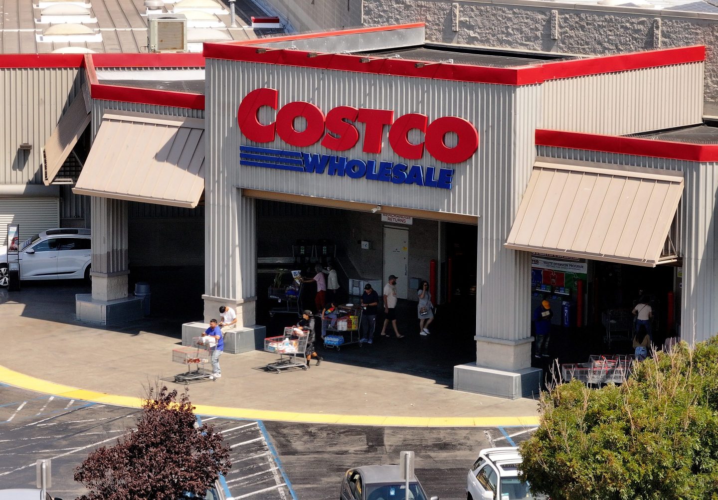 In an aerial view, the Costco logo is displayed on the exterior of a Costco store.