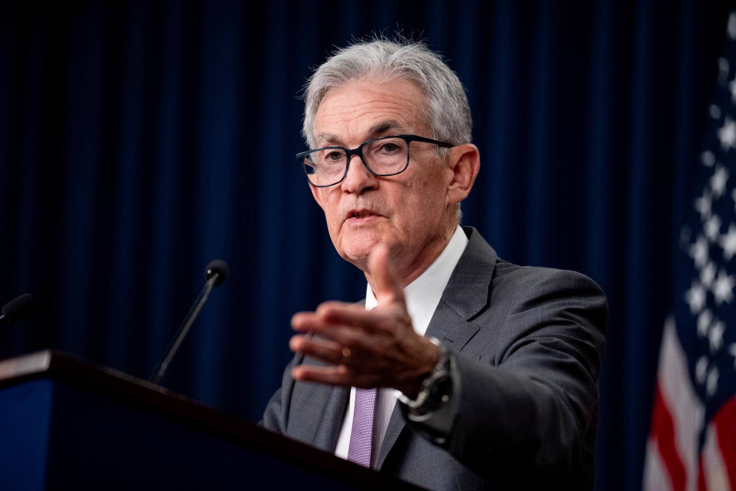 Chair of the Federal Reserve, Jerome Powell, stands at a podium to give a speech on July 31