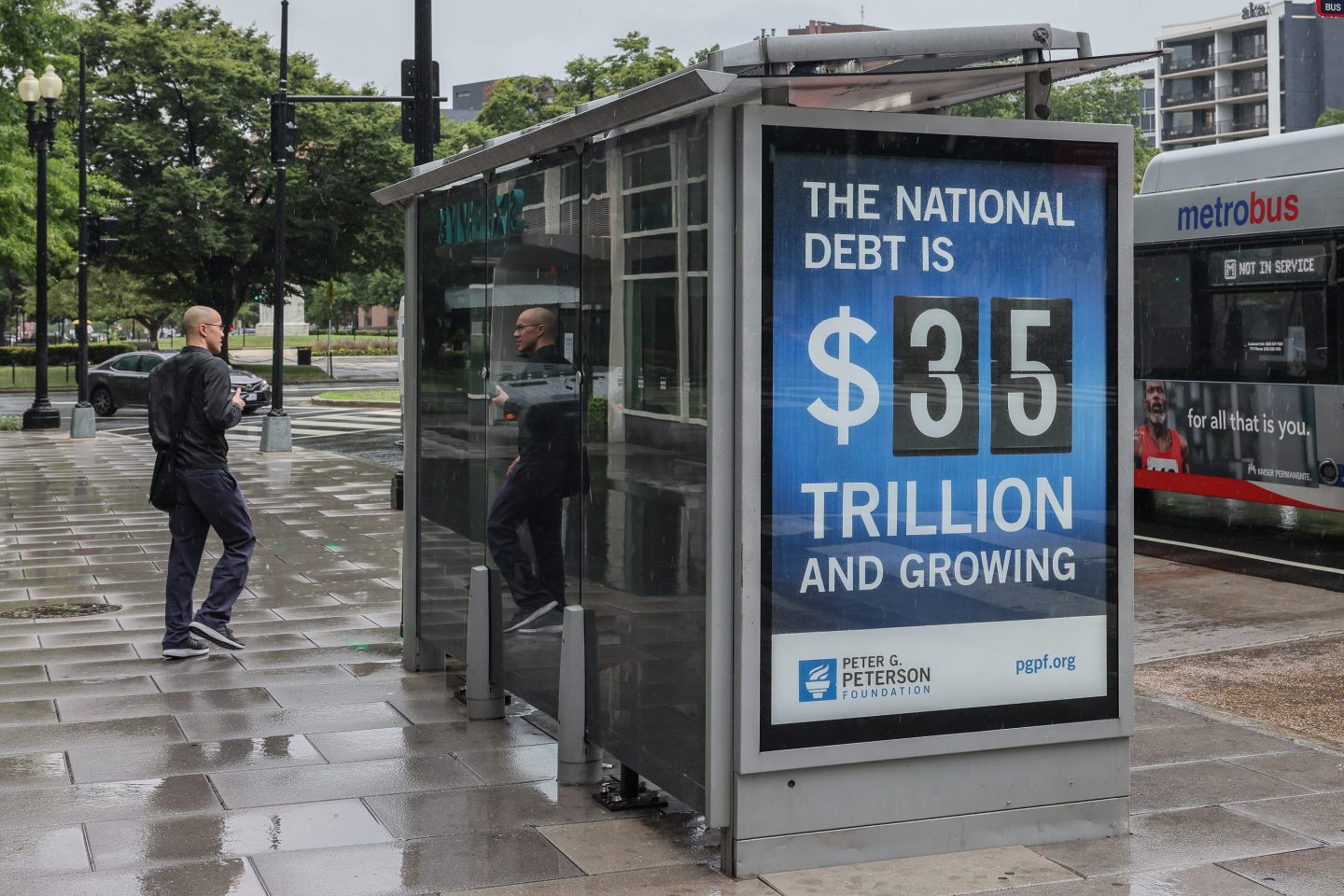 A bus shelter on Pennsylvania Avenue displays U.S. National debt figures on Aug. 8.