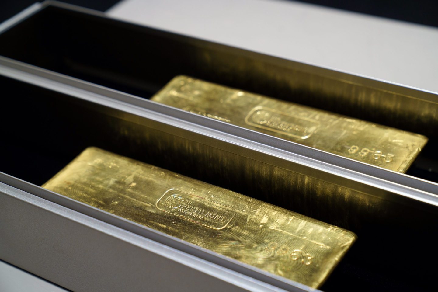 Two inscribed gold bars in a vault.