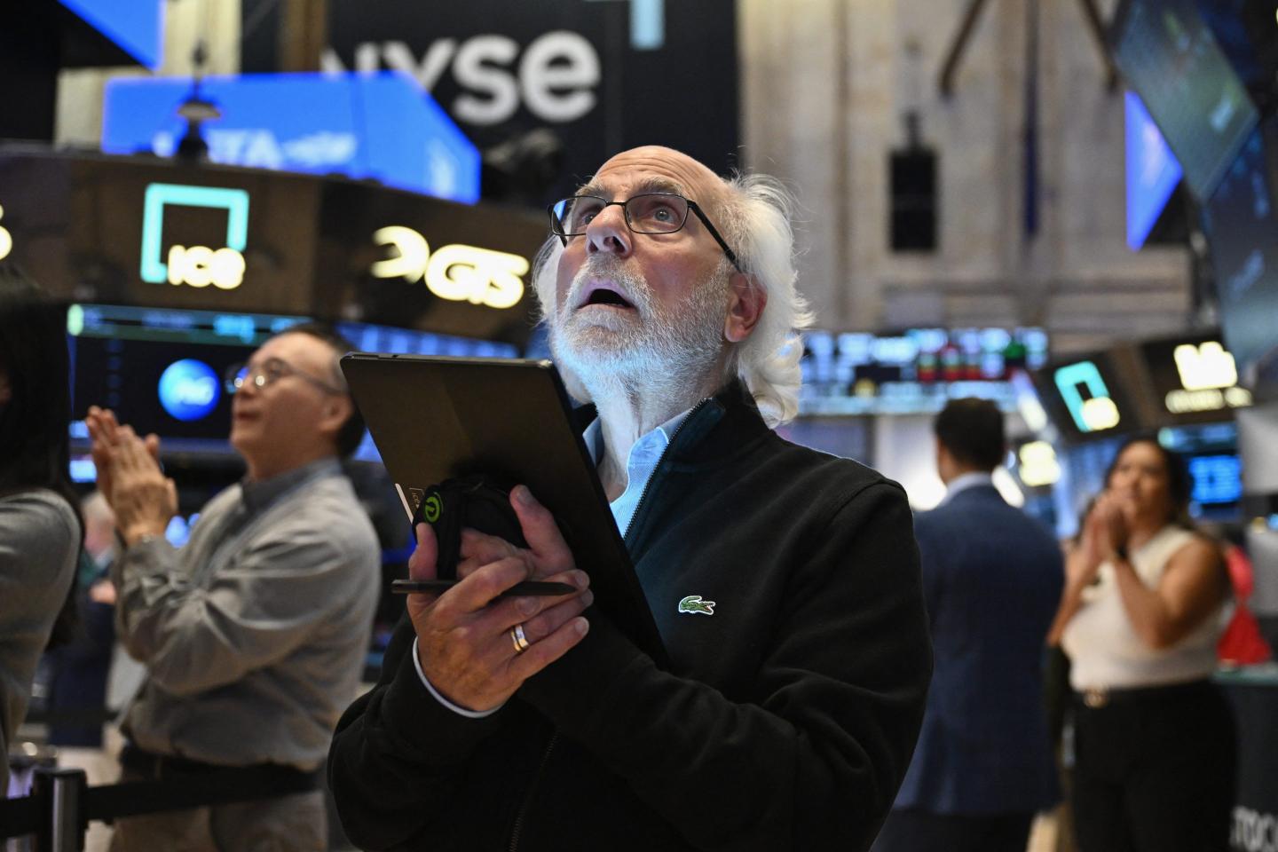 Traders work on the floor of the New York Stock Exchange (NYSE) during morning trading in New York on August 23, 2024.