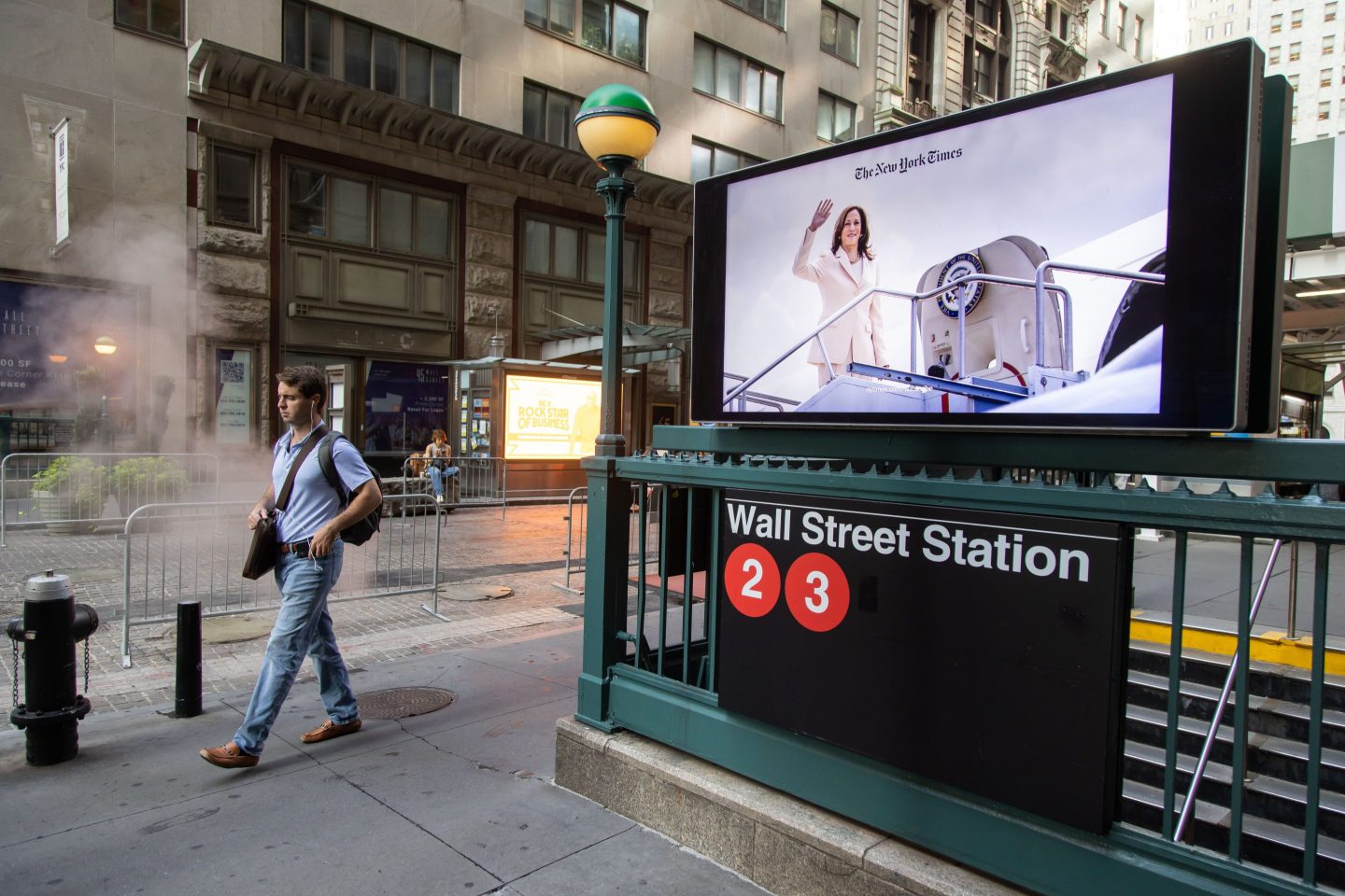 A screen displays an image of U.S. Vice President Kamala Harris at a Wall Street subway station near the New York Stock Exchange on Aug. 23.