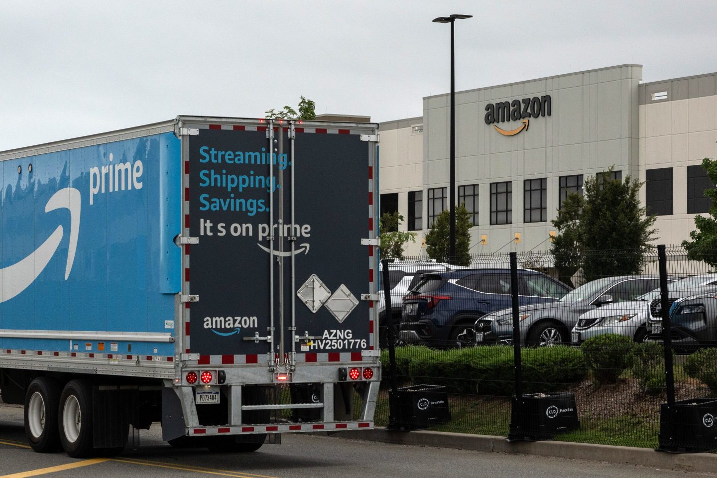 A delivery truck drives past an Amazon warehouse in the Staten Island borough of New York