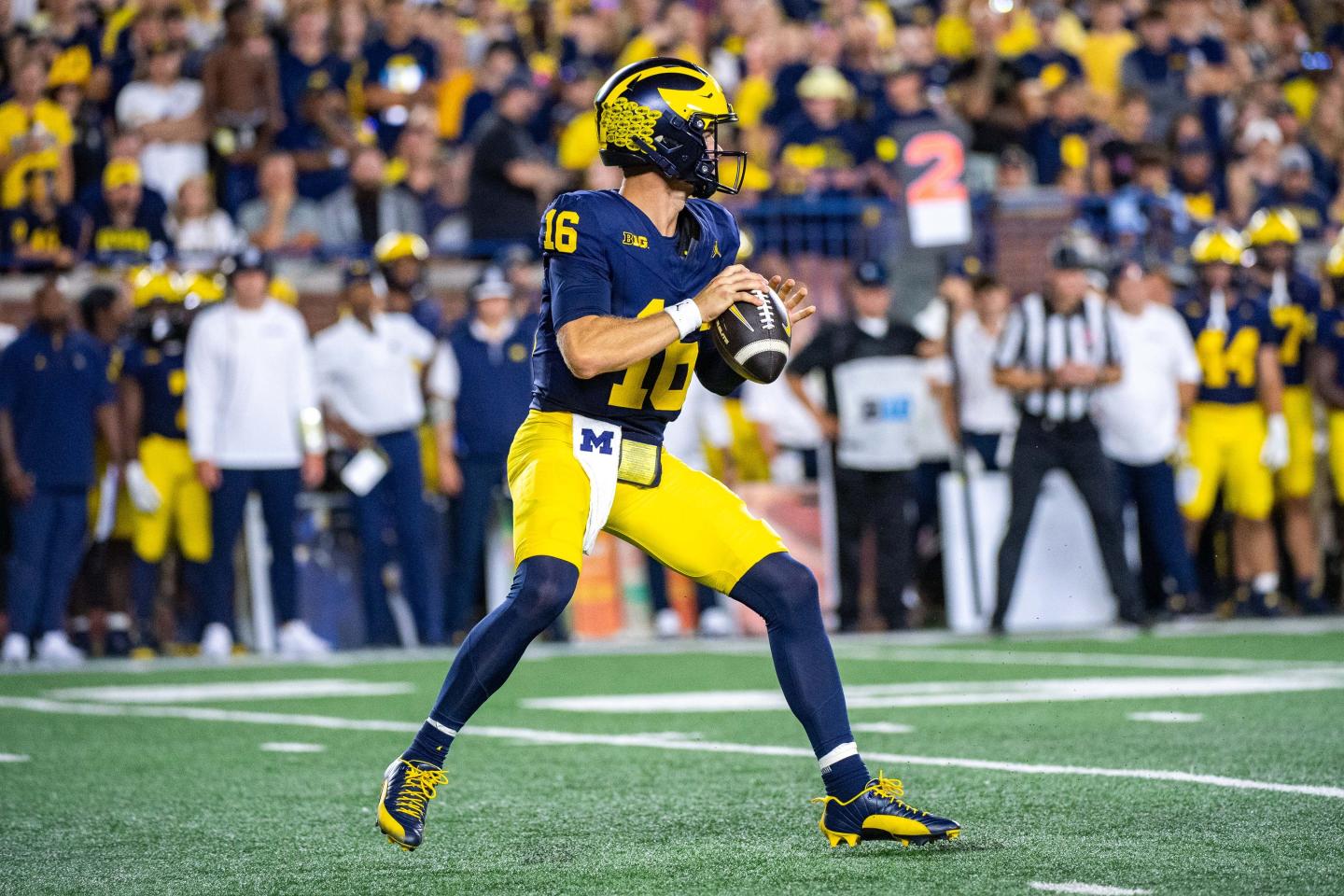 quarterback holds football