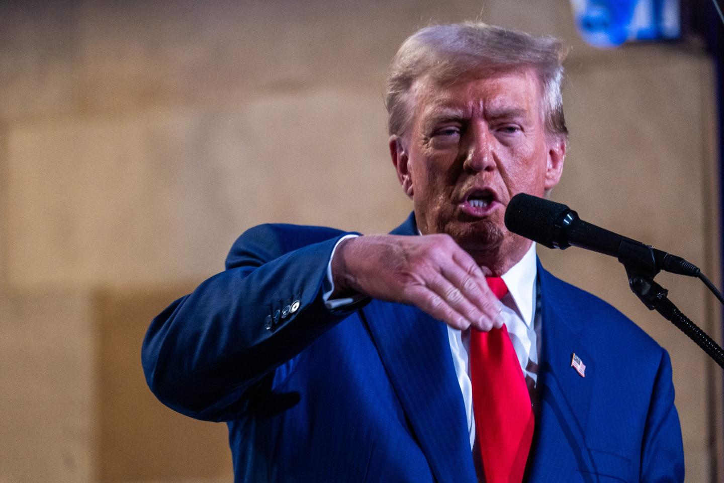 Donald Trump speaks into microphone