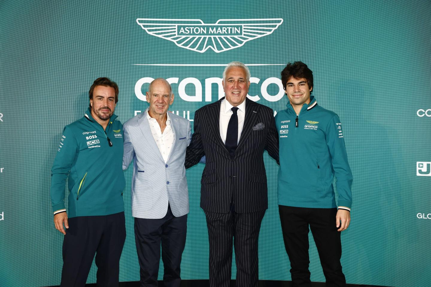 Fernando Alonso, Adrian Newey, Lawrence Stroll, and Lance Stroll of the Aston Martin F1 Team pose together at a press conference held at Aston Martin Headquarters in Silverstone, England, on September 10, 2024.