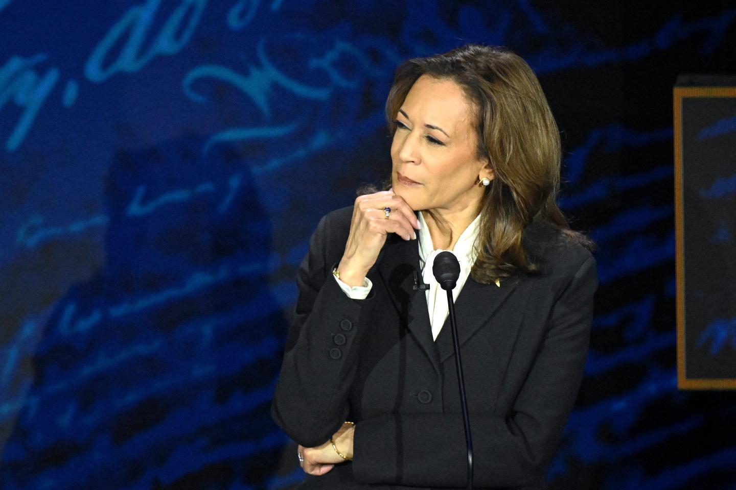 Kamala Harris places her right hand on her chin and gives a quizzical look at Donald Trump (not pictured) during their presidential debate.