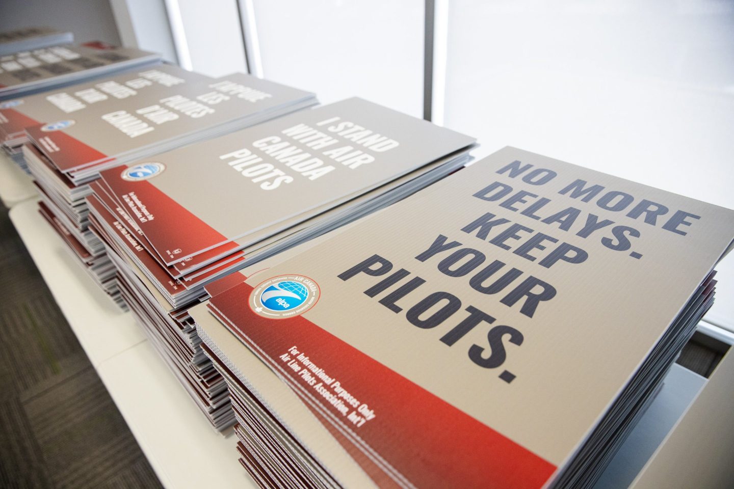 Hundreds of strike signs sit ready as Air Canada pilots prepare for potential strike action, on Sept. 12, 2024.