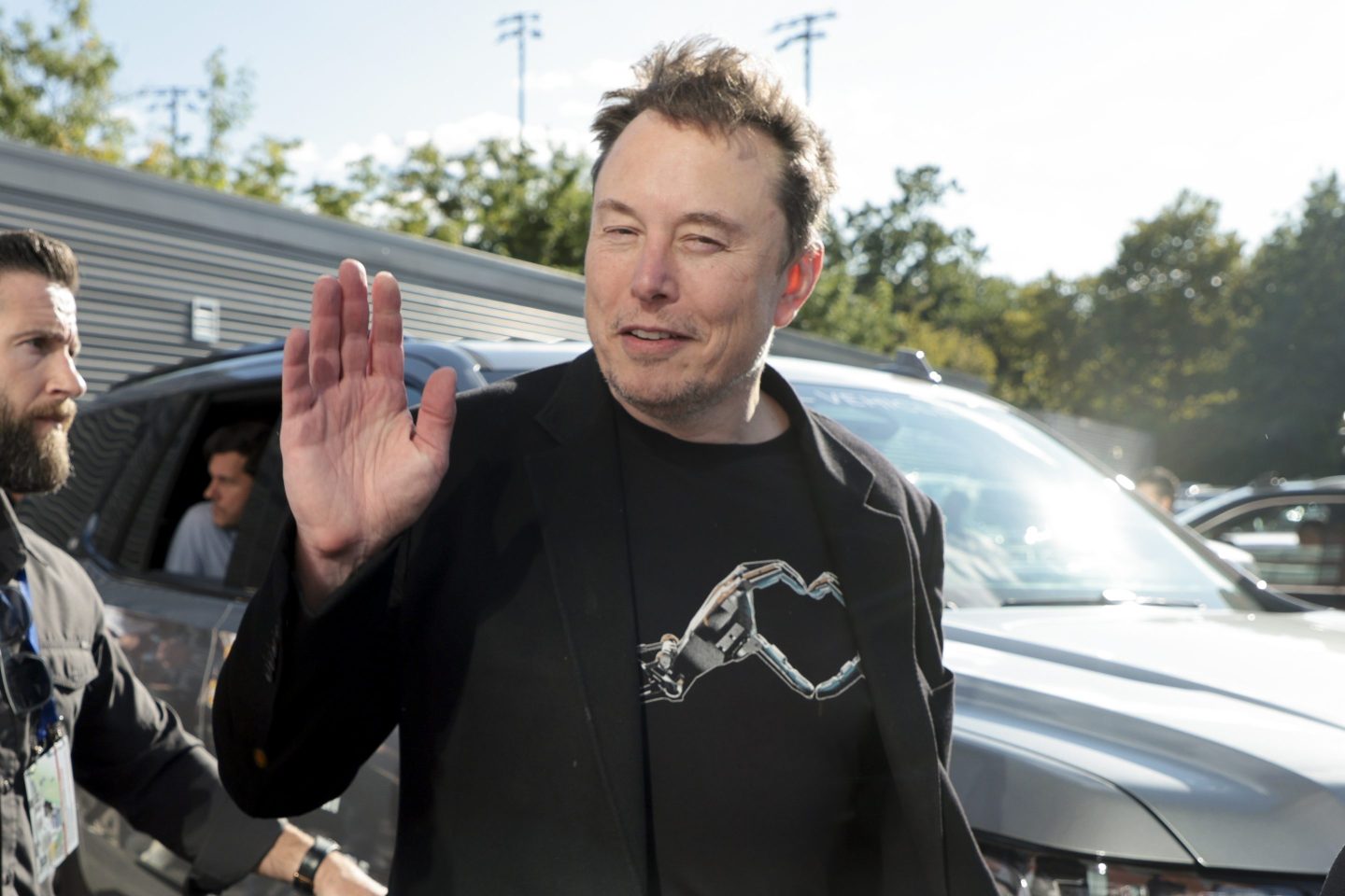 Elon Musk waves