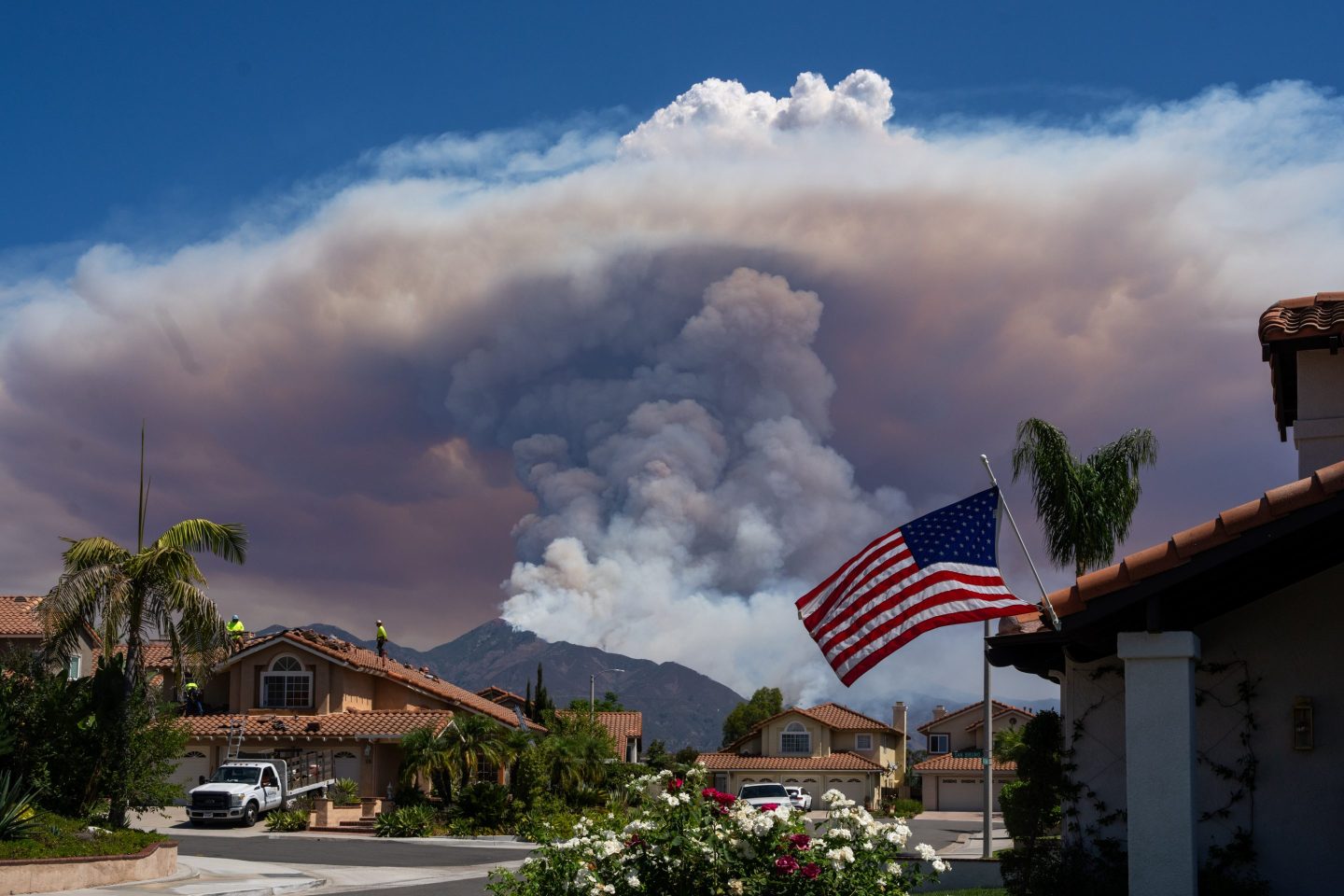 Heavy smoke rises from a wildfire burning in a mountain near a residential area in Irvine, California on Sep. 10.